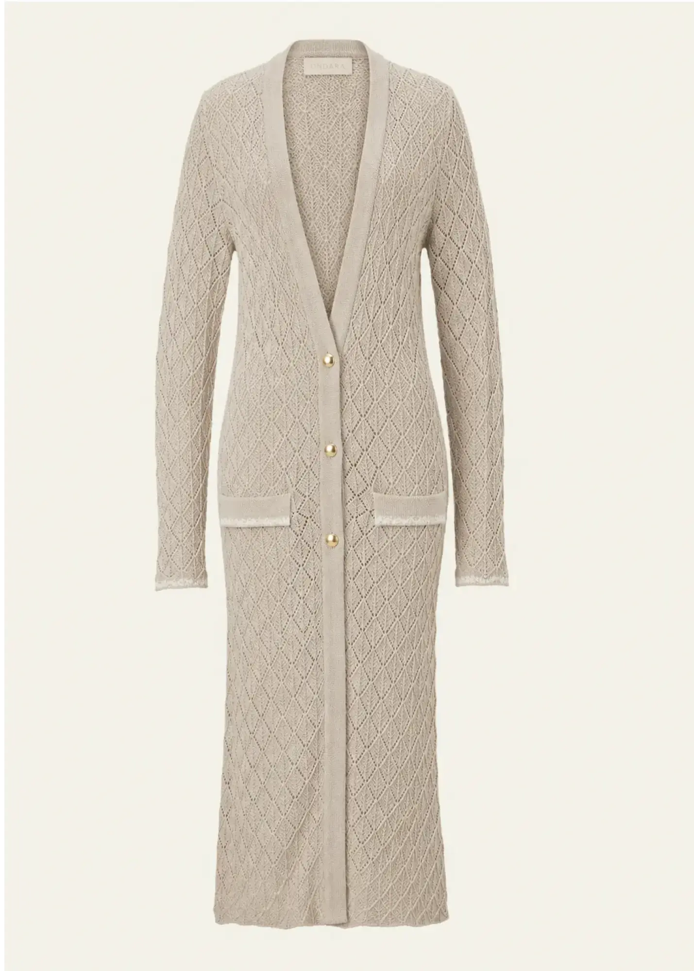 Luxury designer knitwear women by Ondara featuring a premium cotton longline cardigan with intricate geometric openwork knit, exquisite hand-embroidered pockets and matte gold buttons.