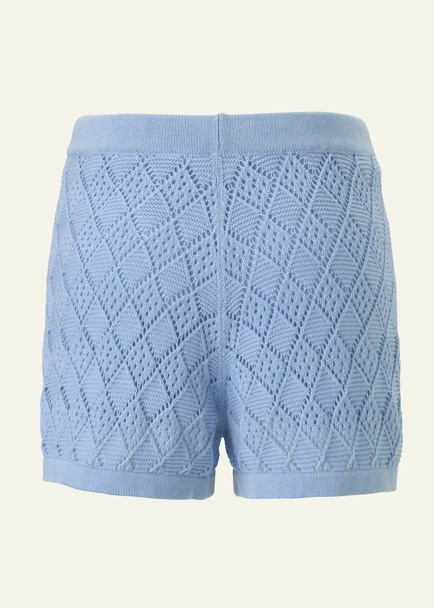Back view of luxury women’s crochet knit shorts in soft sky blue cotton, featuring an intricate openwork diamond pattern and a comfortable elastic waistband. Lightweight designer resort shorts by Ondara, crafted for elegant summer and beachwear styling.