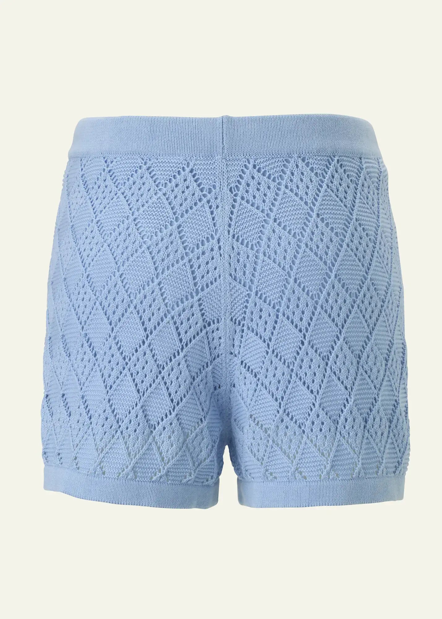 Back view of luxury women’s crochet knit shorts in soft sky blue cotton, featuring an intricate openwork diamond pattern and a comfortable elastic waistband. Lightweight designer resort shorts by Ondara, crafted for elegant summer and beachwear styling.